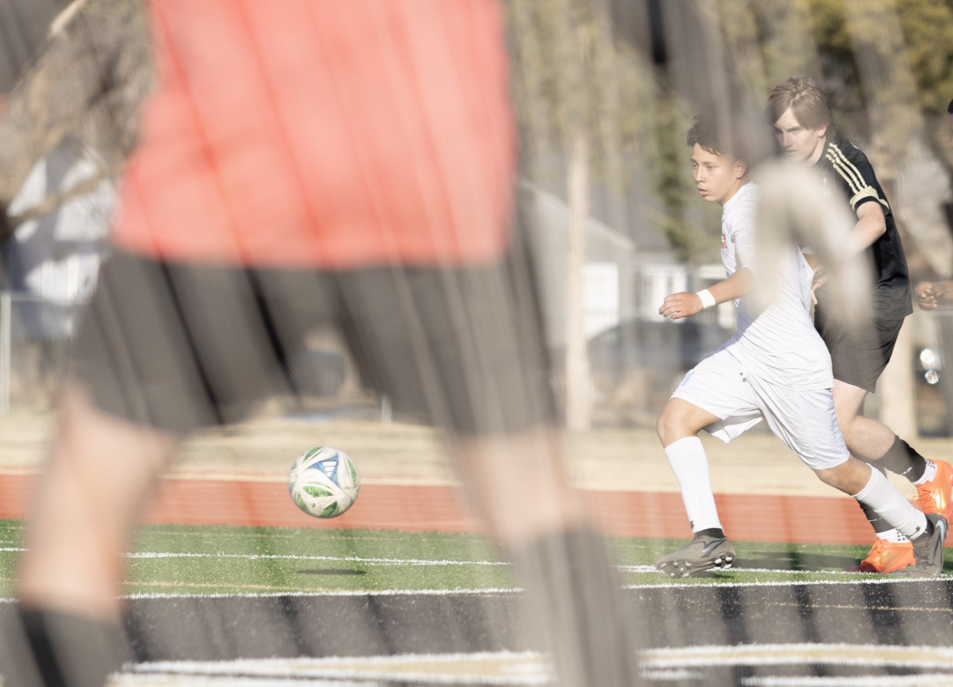 Player dribbling through net